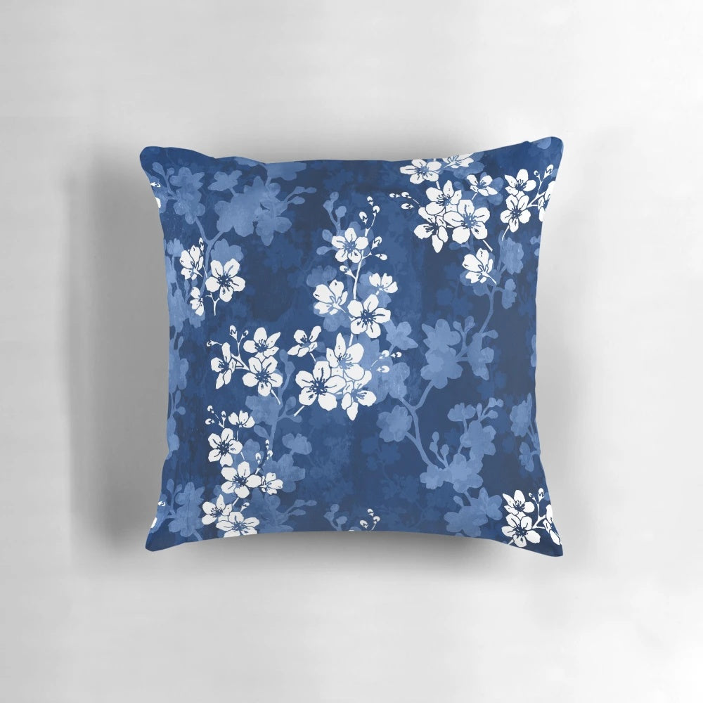 Detailed image of a pillow featuring a watercolor-style pattern of sakura blossoms in shades of blue.