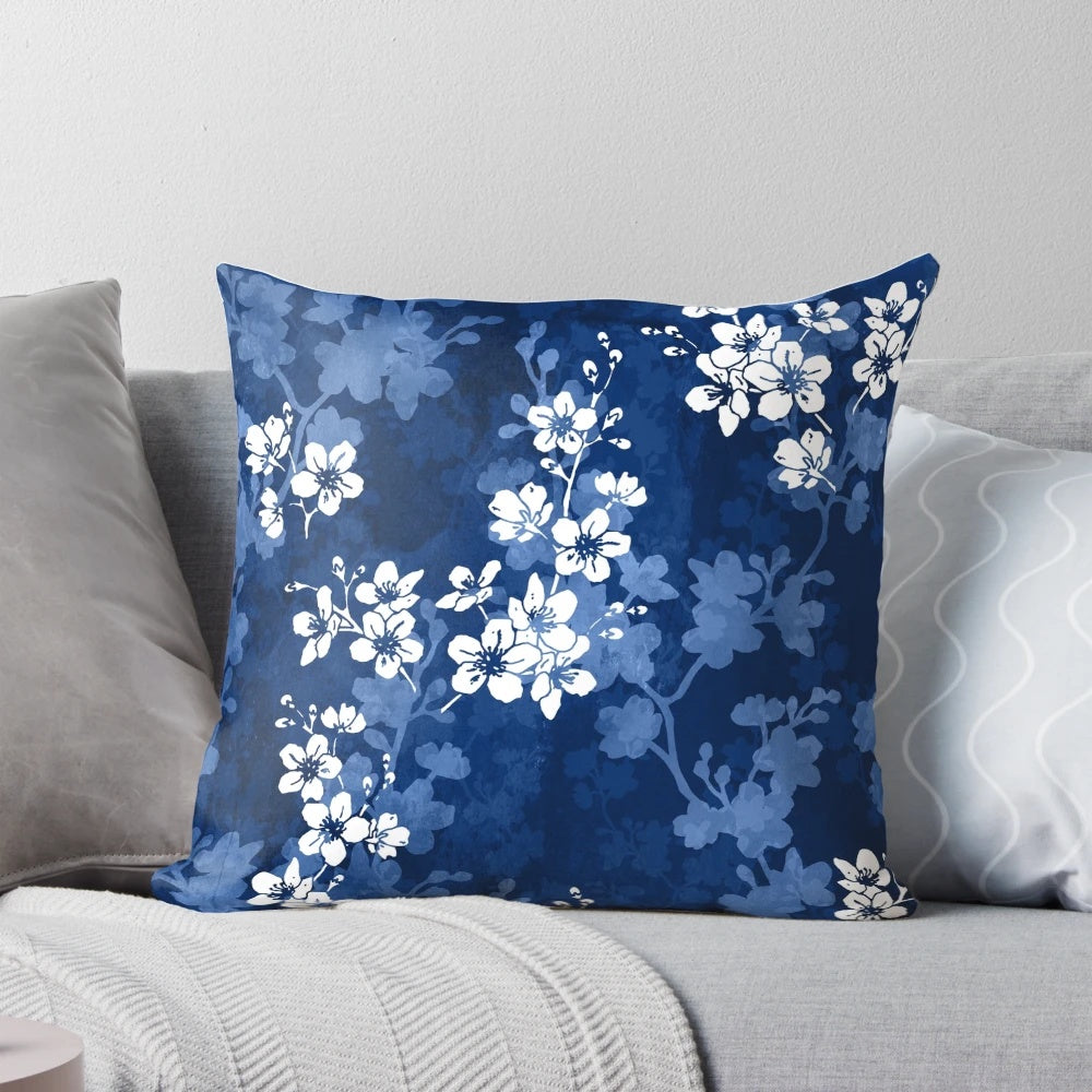 Detailed image of a pillow featuring a watercolor-style pattern of sakura blossoms in shades of blue.