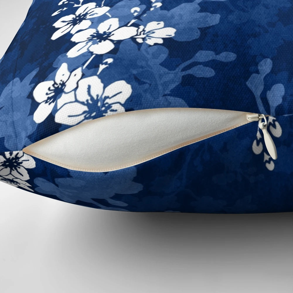 Detailed image of a pillow featuring a watercolor-style pattern of sakura blossoms in shades of blue.