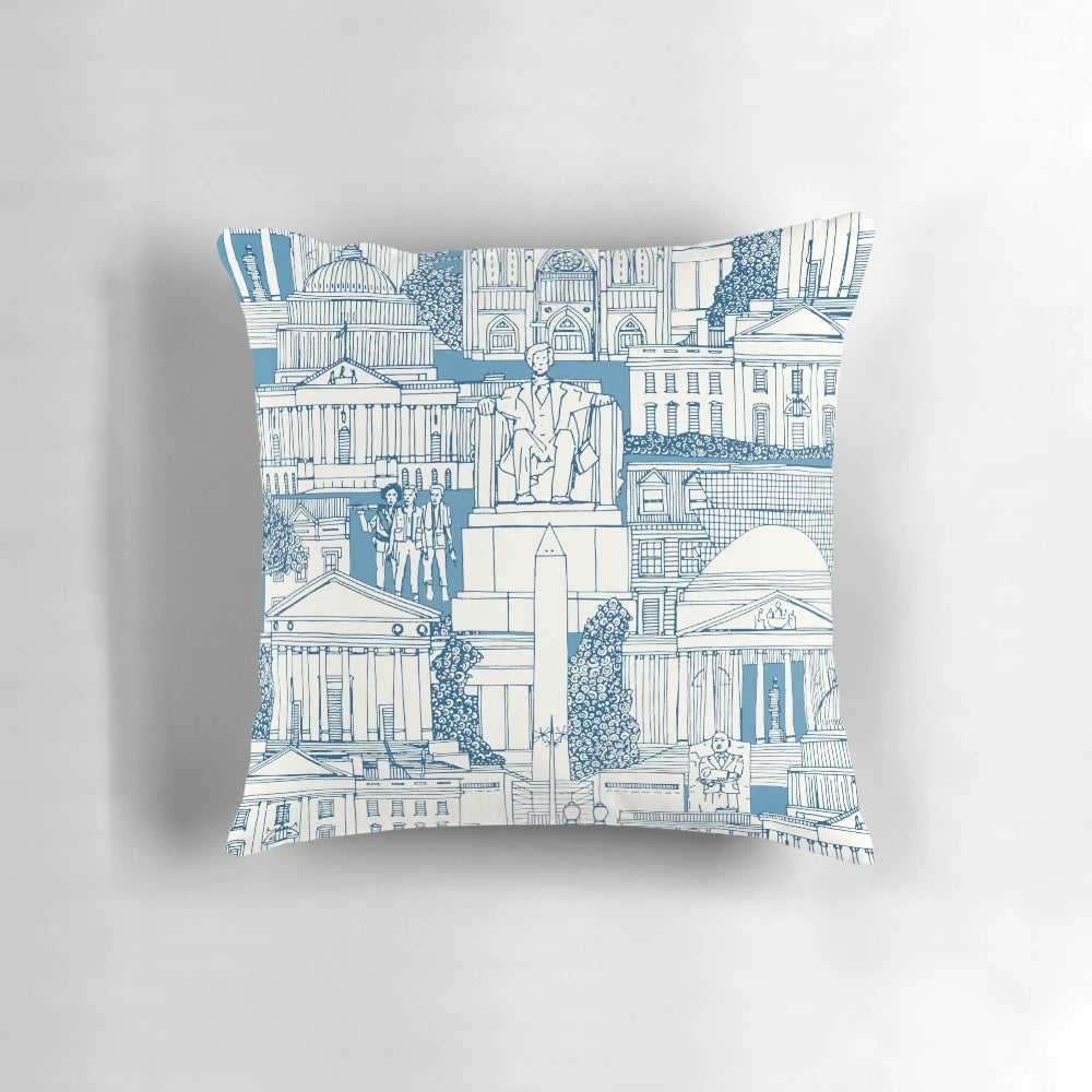 Blue and white toile pillow featuring iconic Washington DC landmarks like the Capitol Building, White House, and monuments.