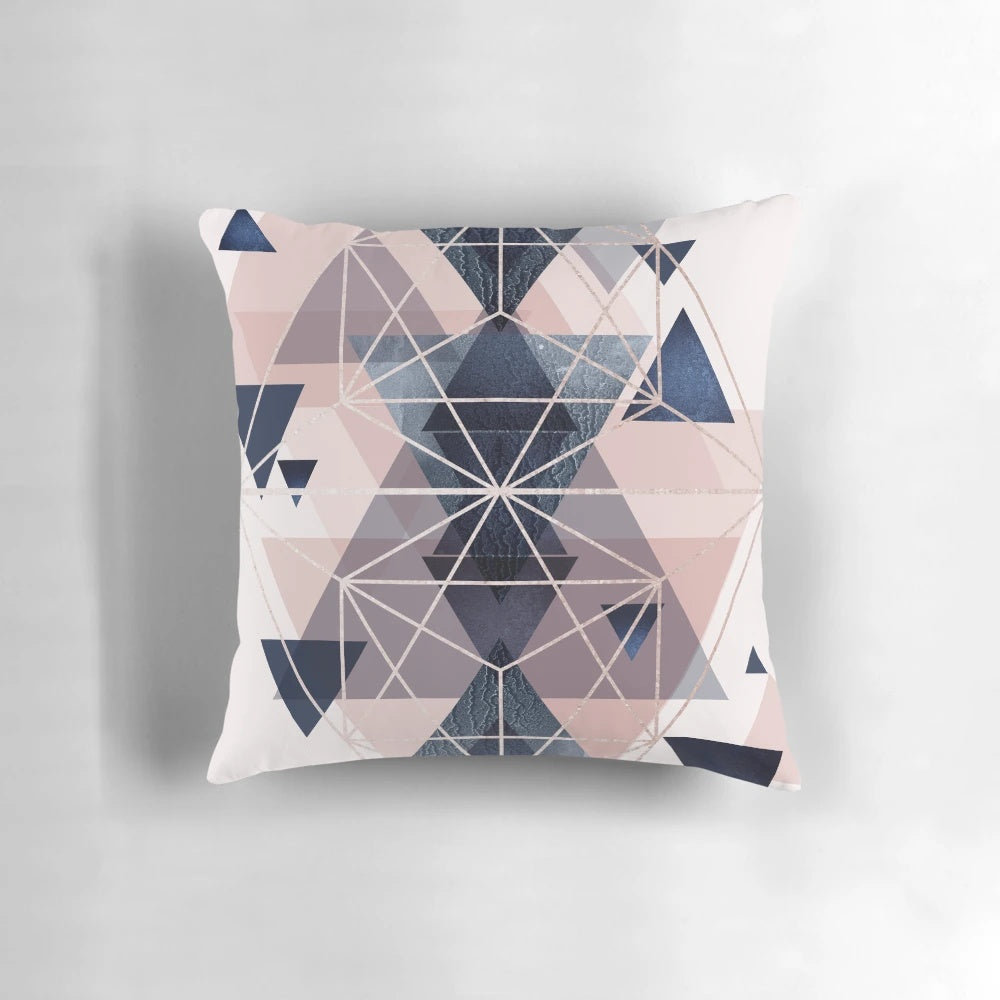 Blush pink and navy blue geometric pillow with triangles and hexagons