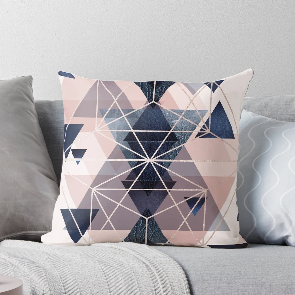 Blush pink and navy blue geometric pillow with triangles and hexagons
