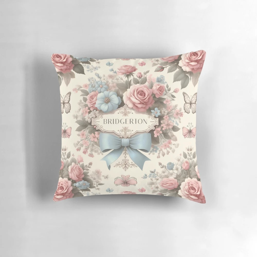 A soft, pastel-colored Bridgerton-inspired Polin pillow with delicate floral and satin bow design, perfect for adding a touch of whimsical elegance to your home.