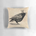 A stylish throw pillow featuring a black and white raven or crow wearing a crown, perfect for adding a touch of whimsy to your home decor.