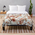Soft and cozy plush blanket with a detailed cherry blossom floral pattern