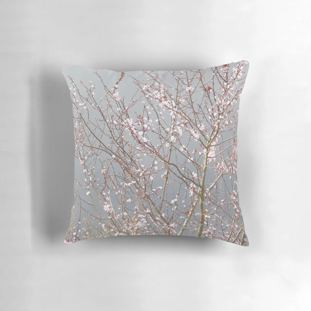 Soft, plush pillow featuring a beautiful cherry blossom floral design in shades of pink and grey.