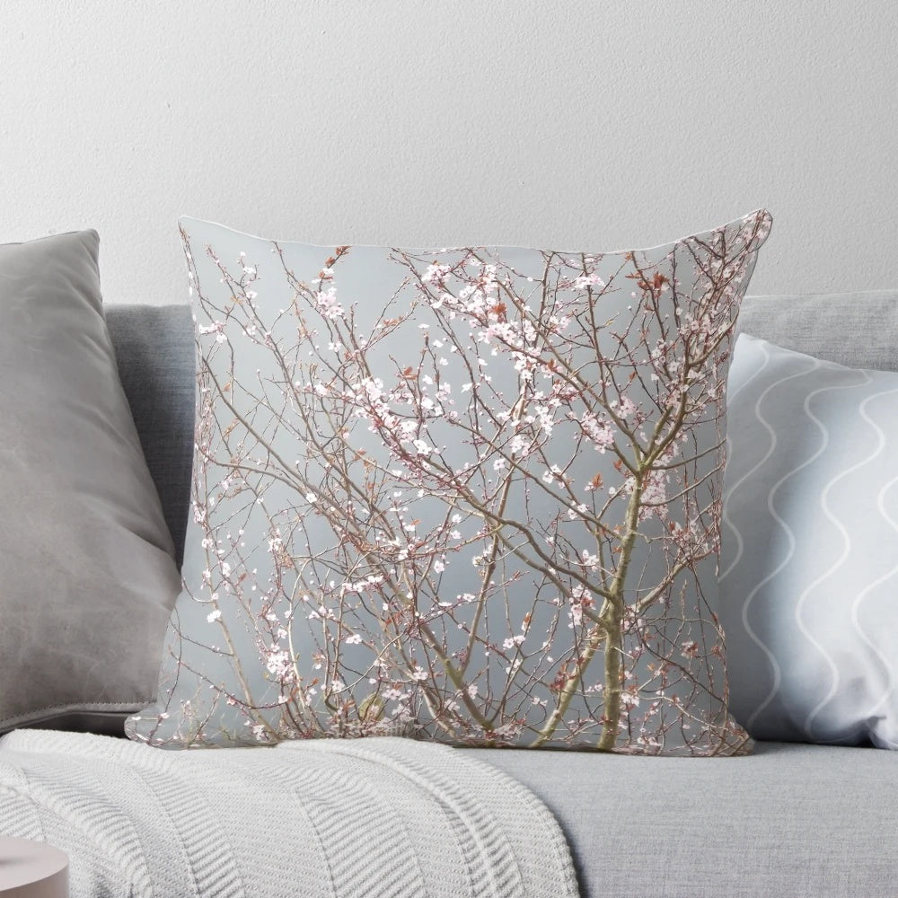 Soft, plush pillow featuring a beautiful cherry blossom floral design in shades of pink and grey.