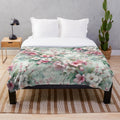 Cherry blossom patterned plush blanket with pink floral design