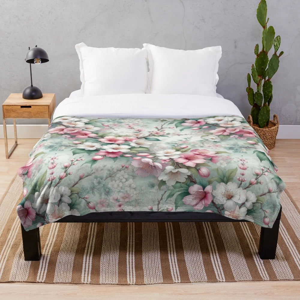 Cherry blossom patterned plush blanket with pink floral design