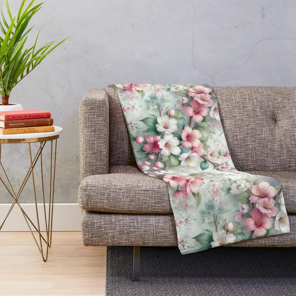 Cherry blossom patterned plush blanket with pink floral design