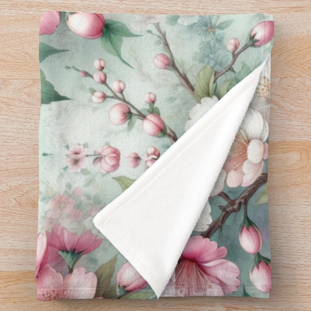 Cherry blossom patterned plush blanket with pink floral design