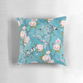 Decorative Chinoiserie-inspired pillow with birds in turquoise blue and floral elements