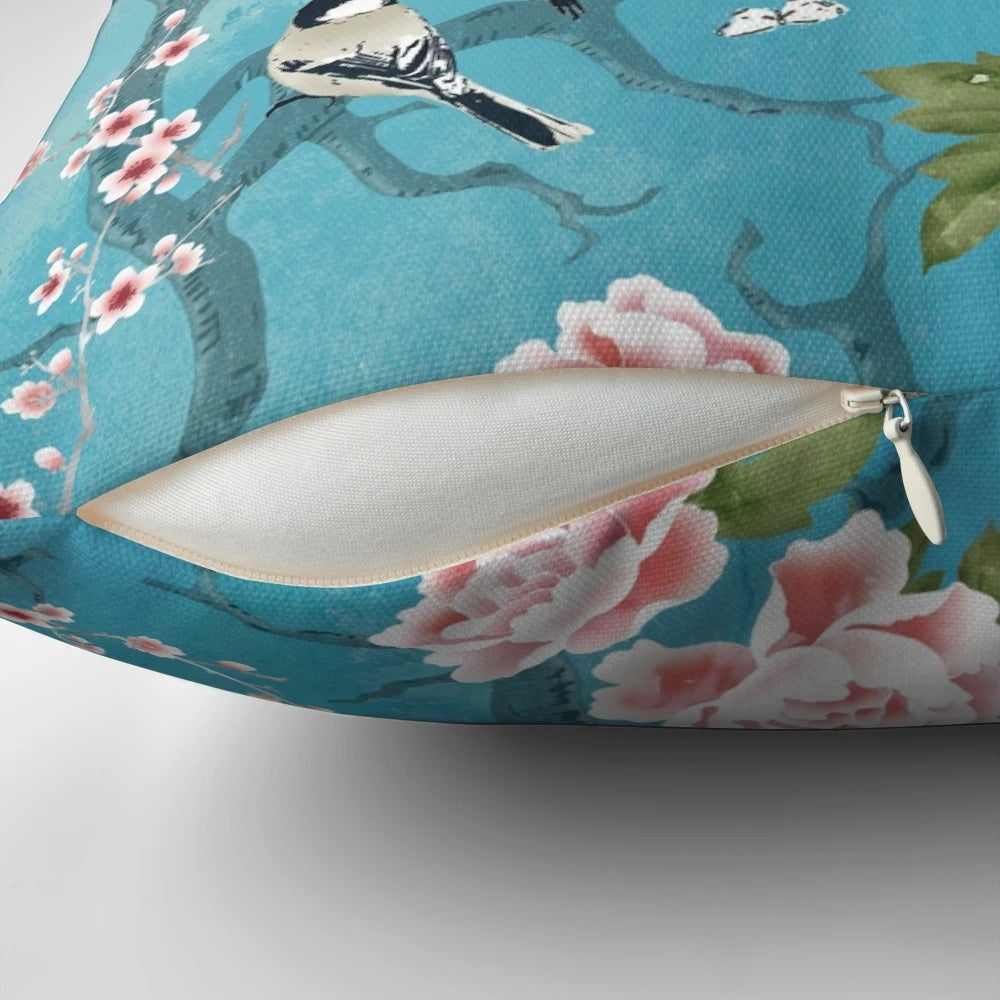 Decorative Chinoiserie-inspired pillow with birds in turquoise blue and floral elements