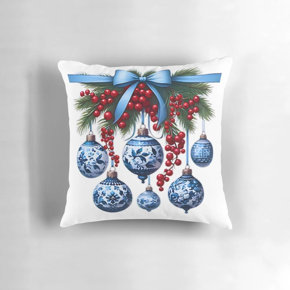 Chinoiserie-inspired blue and white Christmas pillow with pine branches, ornaments, and bows