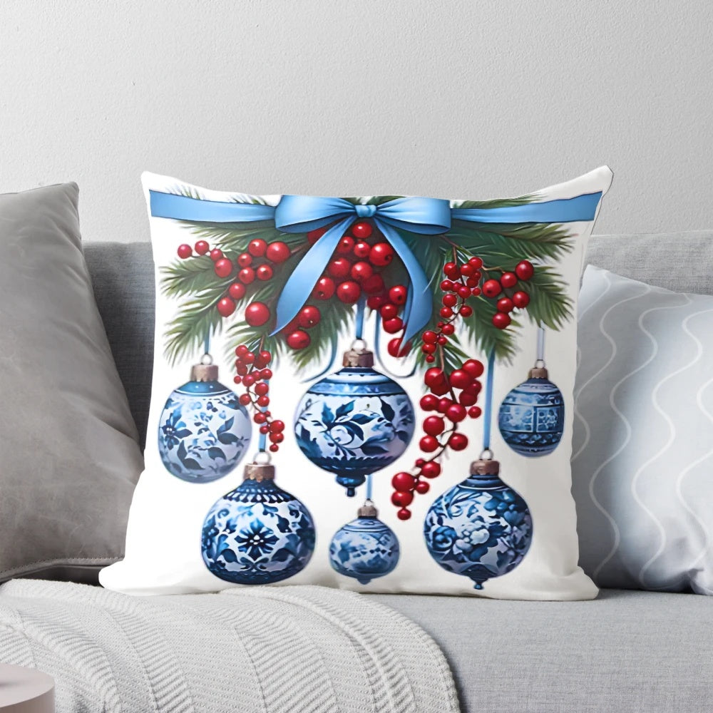 Chinoiserie-inspired blue and white Christmas pillow with pine branches, ornaments, and bows