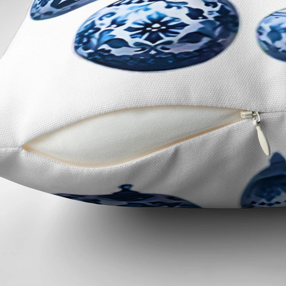 Chinoiserie-inspired blue and white Christmas pillow with pine branches, ornaments, and bows