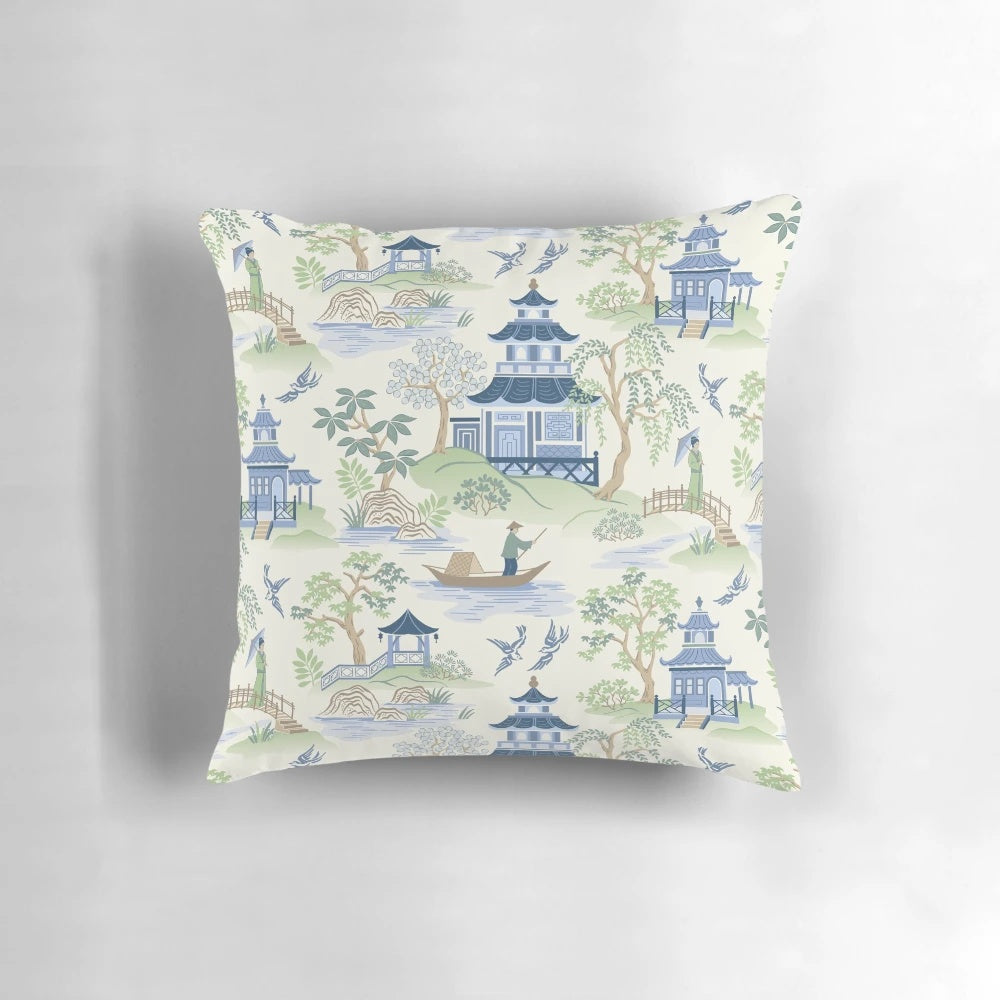Chinoiserie-inspired decorative pillow with pagoda, fishing, and willow pattern design