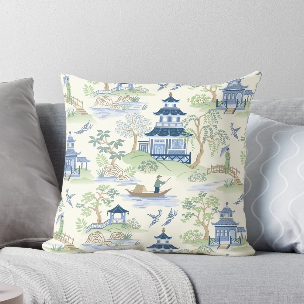 Chinoiserie-inspired decorative pillow with pagoda, fishing, and willow pattern design