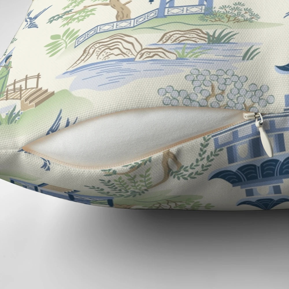 Chinoiserie-inspired decorative pillow with pagoda, fishing, and willow pattern design