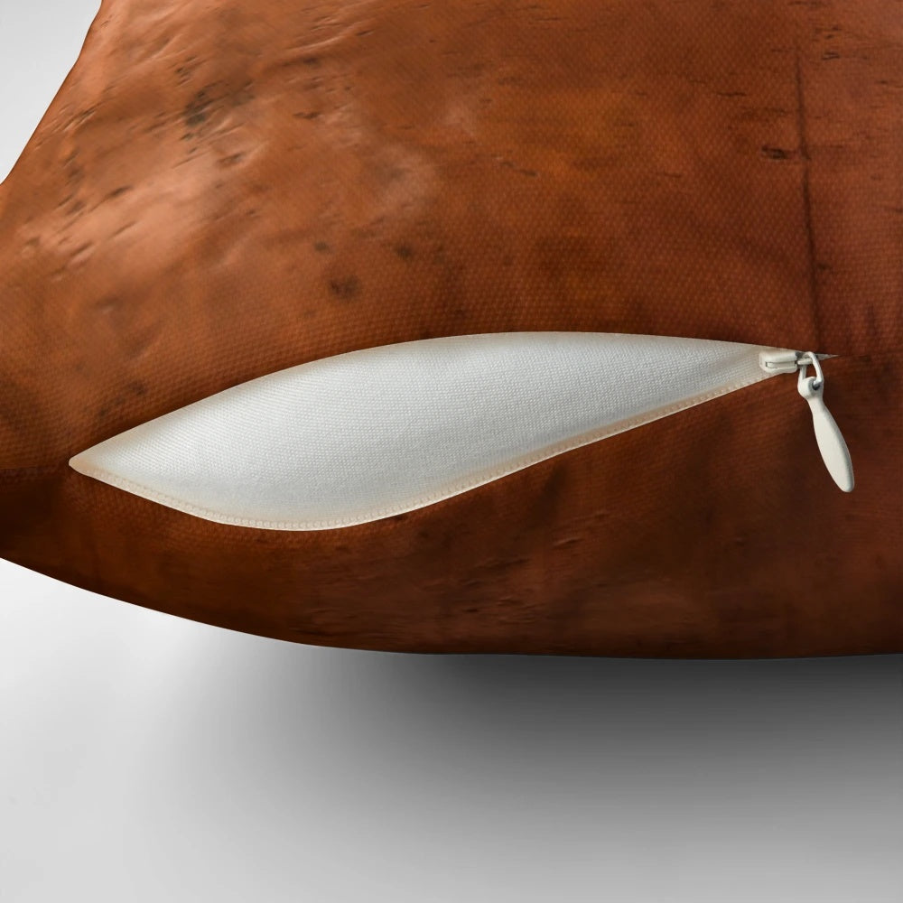 Close-up of a copper metallic pillow with abstract, ray-like design