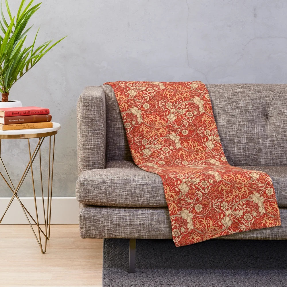 Coral orange plush blanket with art nouveau inspired seaweed and floral pattern