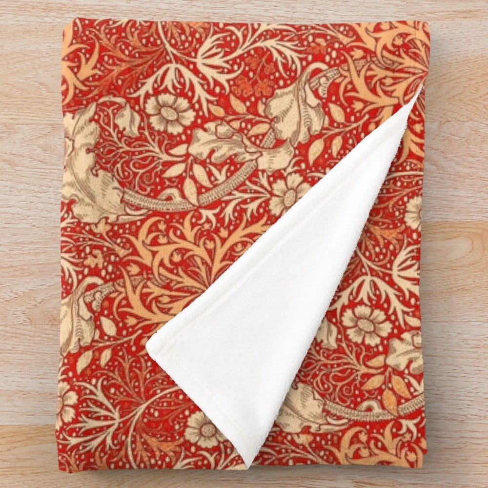 Coral orange plush blanket with art nouveau inspired seaweed and floral pattern