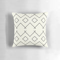 Cream-colored pillow with bohemian geometric patterns, perfect for enhancing your bathing experience.