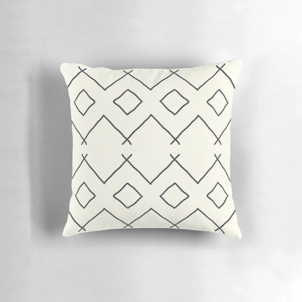 Cream-colored pillow with bohemian geometric patterns, perfect for enhancing your bathing experience.