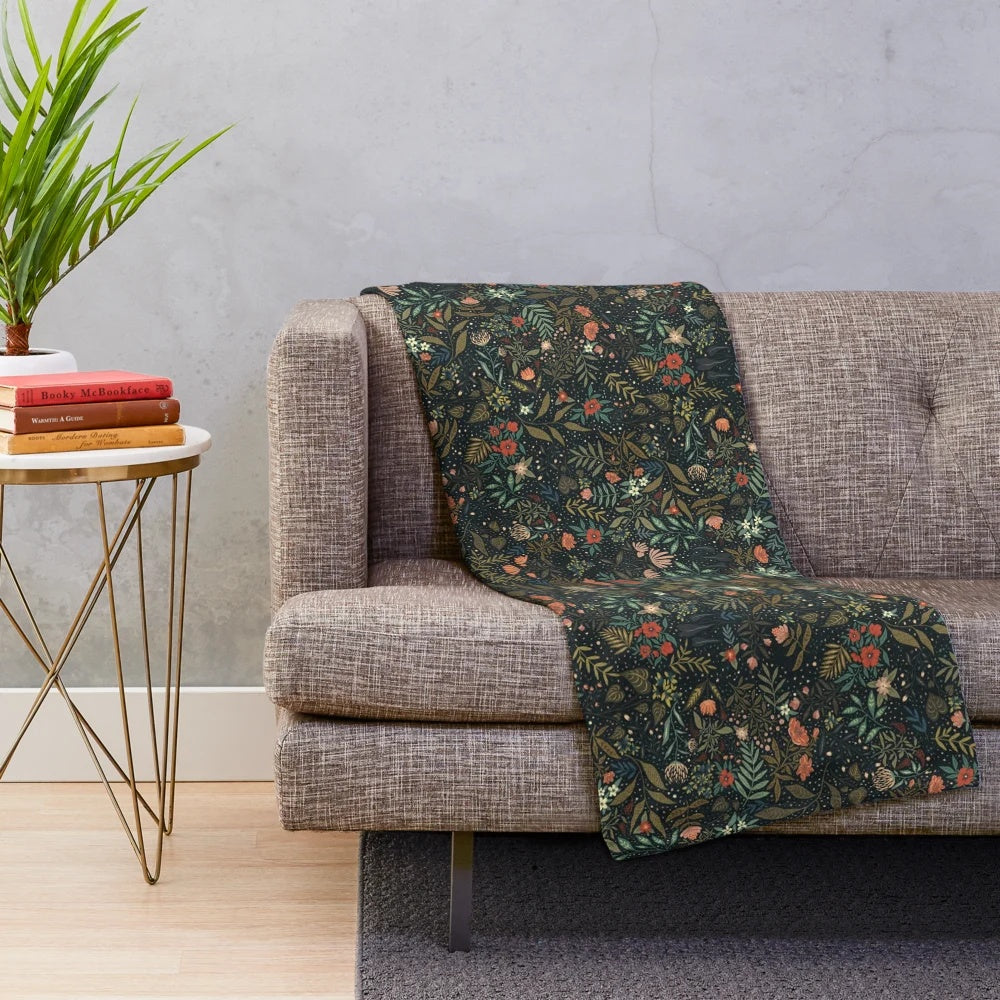 Dark botanical plush blanket with intricate floral and leaf pattern