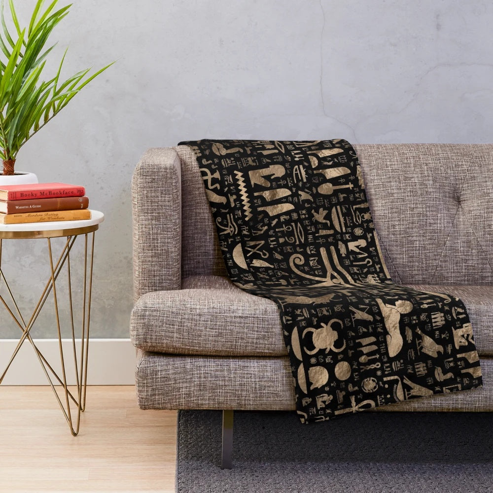 Plush blanket featuring ancient Egyptian hieroglyphic designs in black and gold