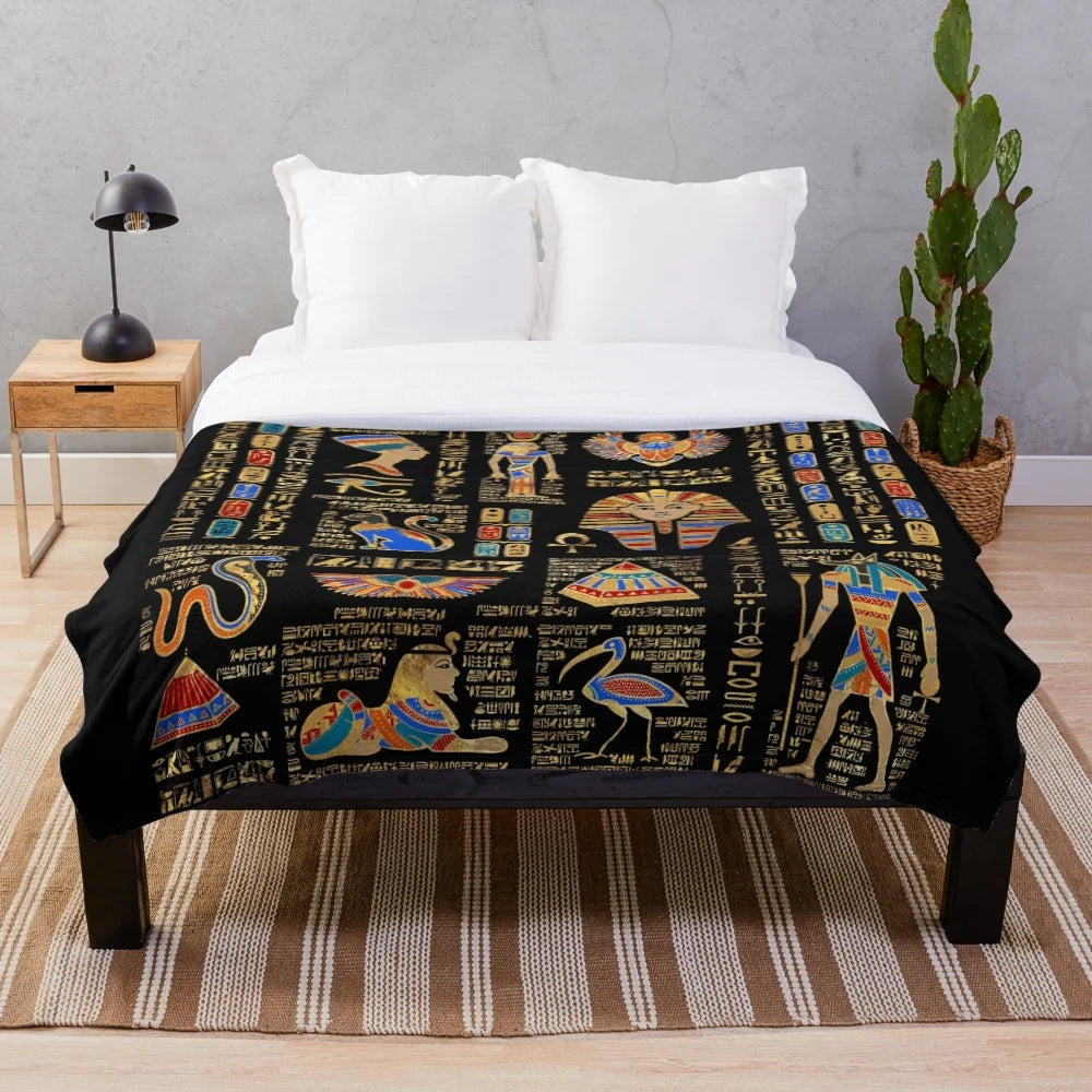 Plush black blanket with golden egyptian hieroglyphs and deities