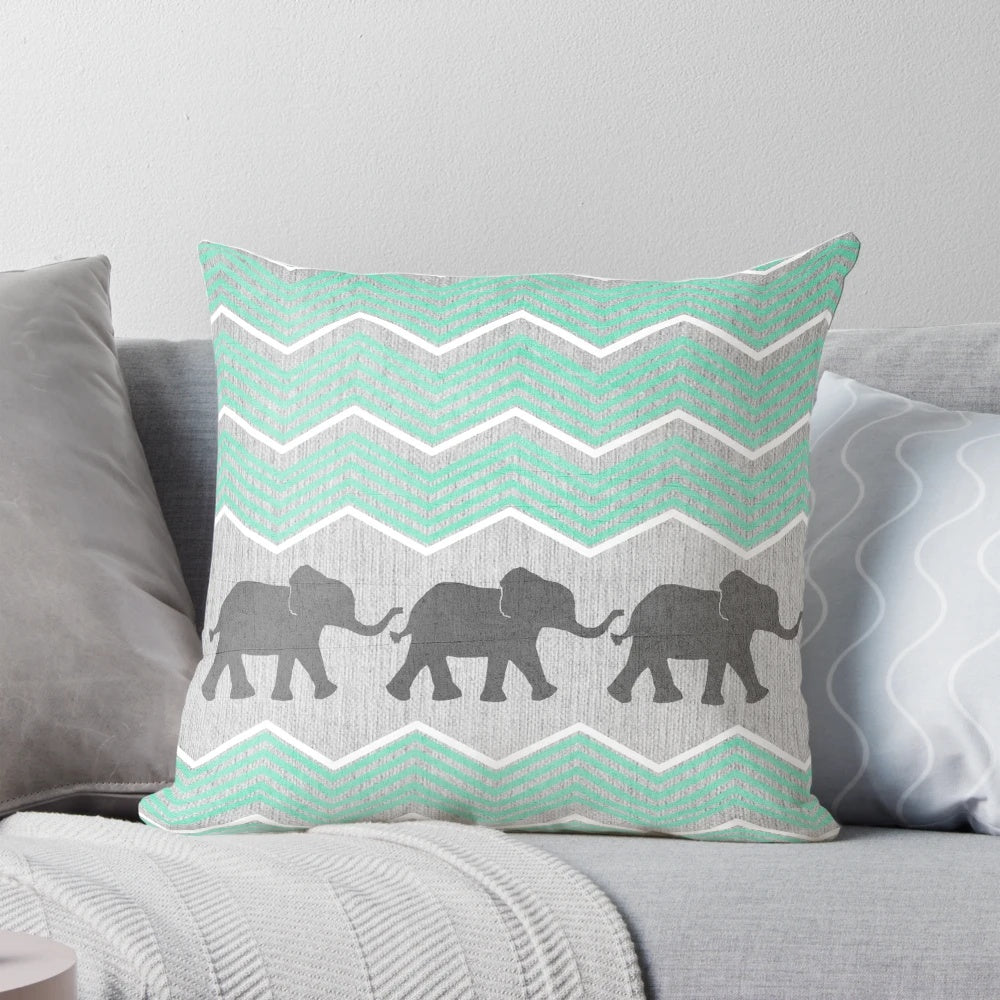 Three stylized elephants in shades of grey, teal, and turquoise on a patterned background.