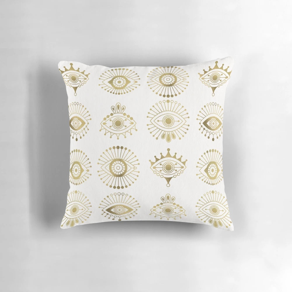 Luxurious gold pillow with evil eye motif, perfect for modern minimalist interior design or yoga/meditation spaces.