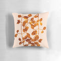 A soft, plush pillow featuring a beautiful arrangement of golden autumn leaves against a pink background.