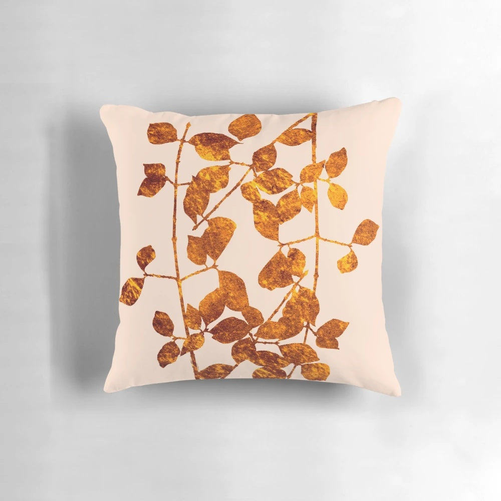 A soft, plush pillow featuring a beautiful arrangement of golden autumn leaves against a pink background.