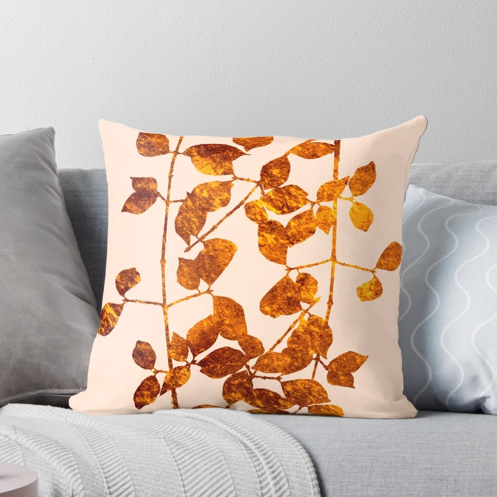 A soft, plush pillow featuring a beautiful arrangement of golden autumn leaves against a pink background.