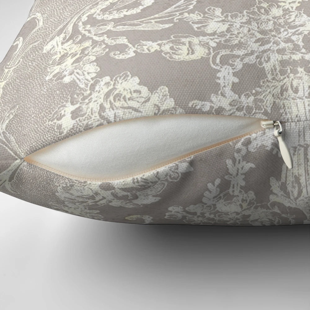 Closeup of a vintage-style grey and white floral lace decorative pillow