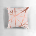 Decorative geometric pillow in a modern pink and copper color scheme