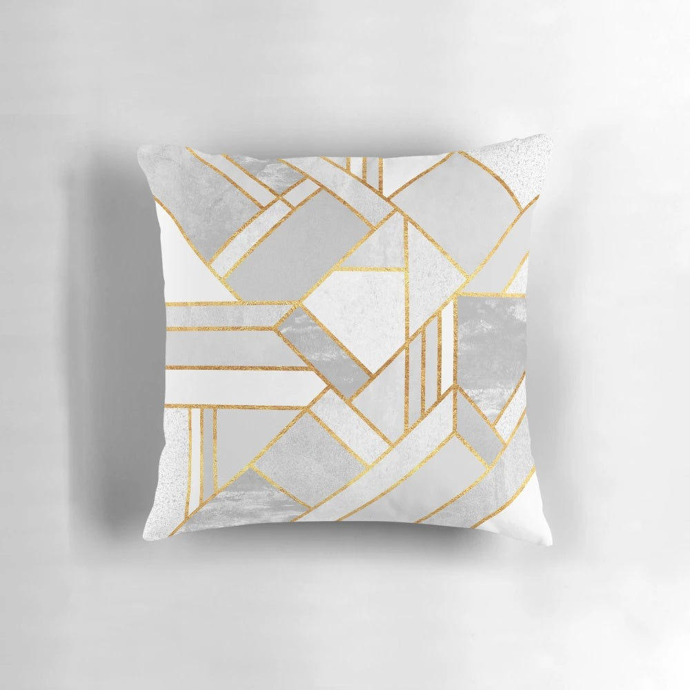 A luxurious modern gold and white geometric pillow with an abstract mosaic design