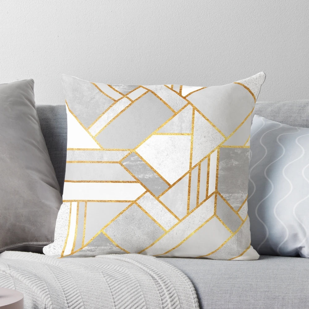 A luxurious modern gold and white geometric pillow with an abstract mosaic design