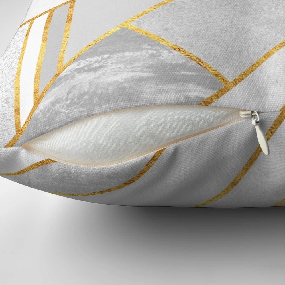 A luxurious modern gold and white geometric pillow with an abstract mosaic design