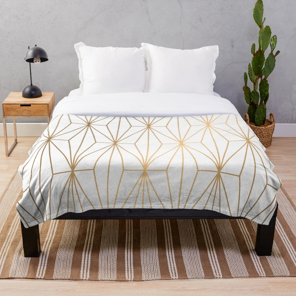 Gold geometric pattern illustration on a plush, shimmering blanket