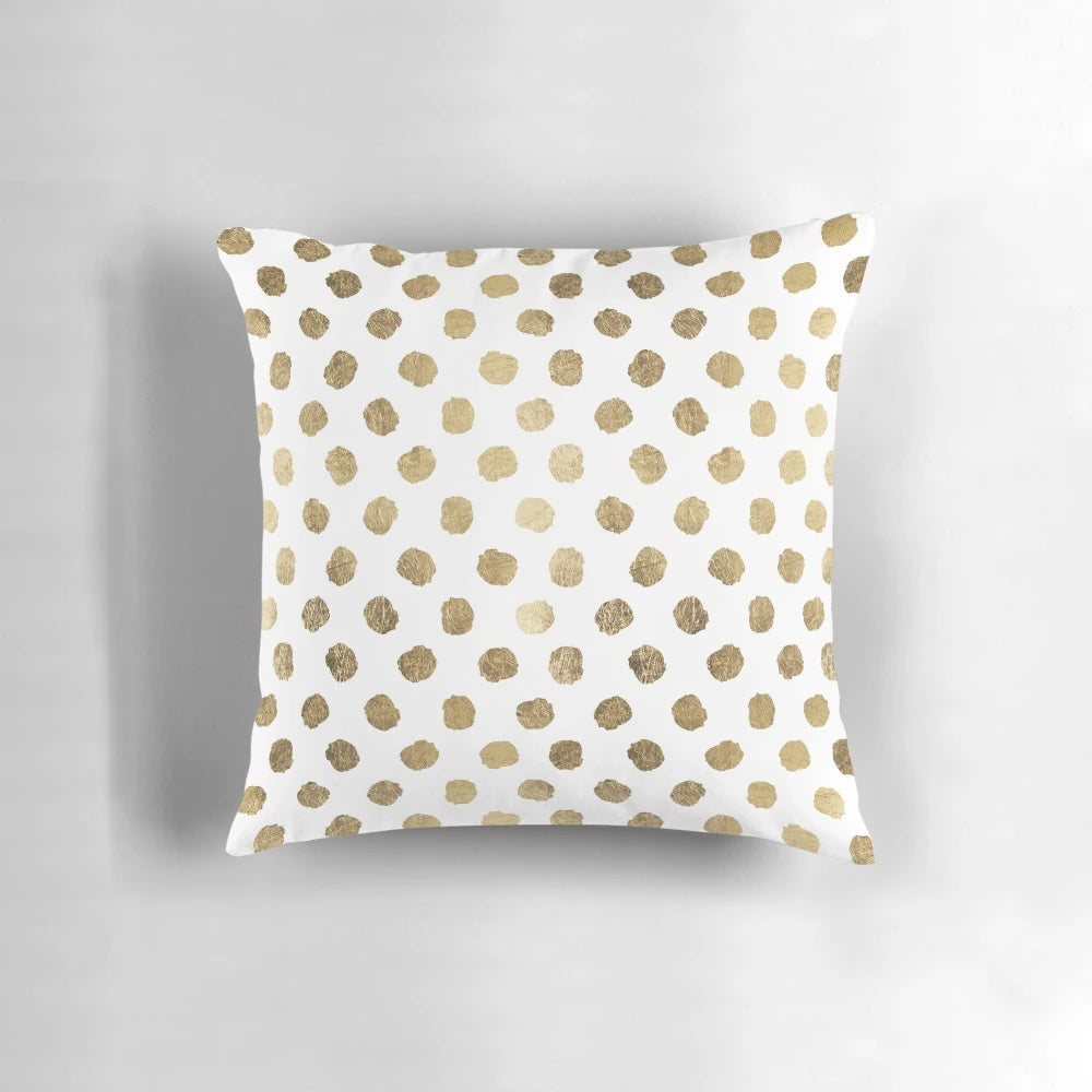 Decorative throw pillow with a modern gold leaf polka dot and brushstroke pattern