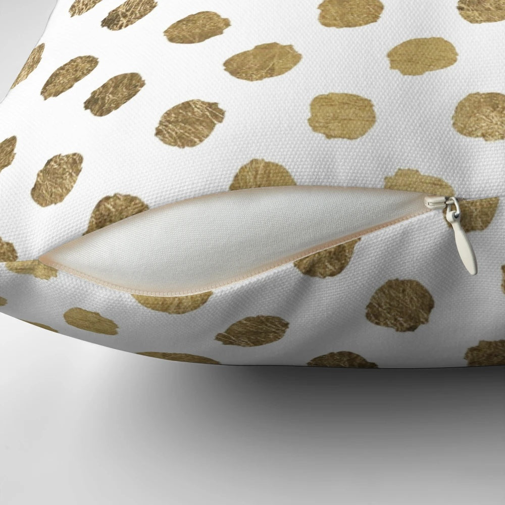 Decorative throw pillow with a modern gold leaf polka dot and brushstroke pattern