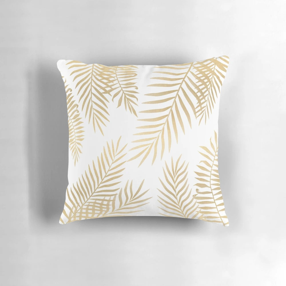 Gold palm leaves decorative pillow with tropical floral pattern