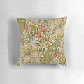A decorative pillow featuring a golden lily flower pattern, inspired by the designs of the English Arts and Crafts movement.