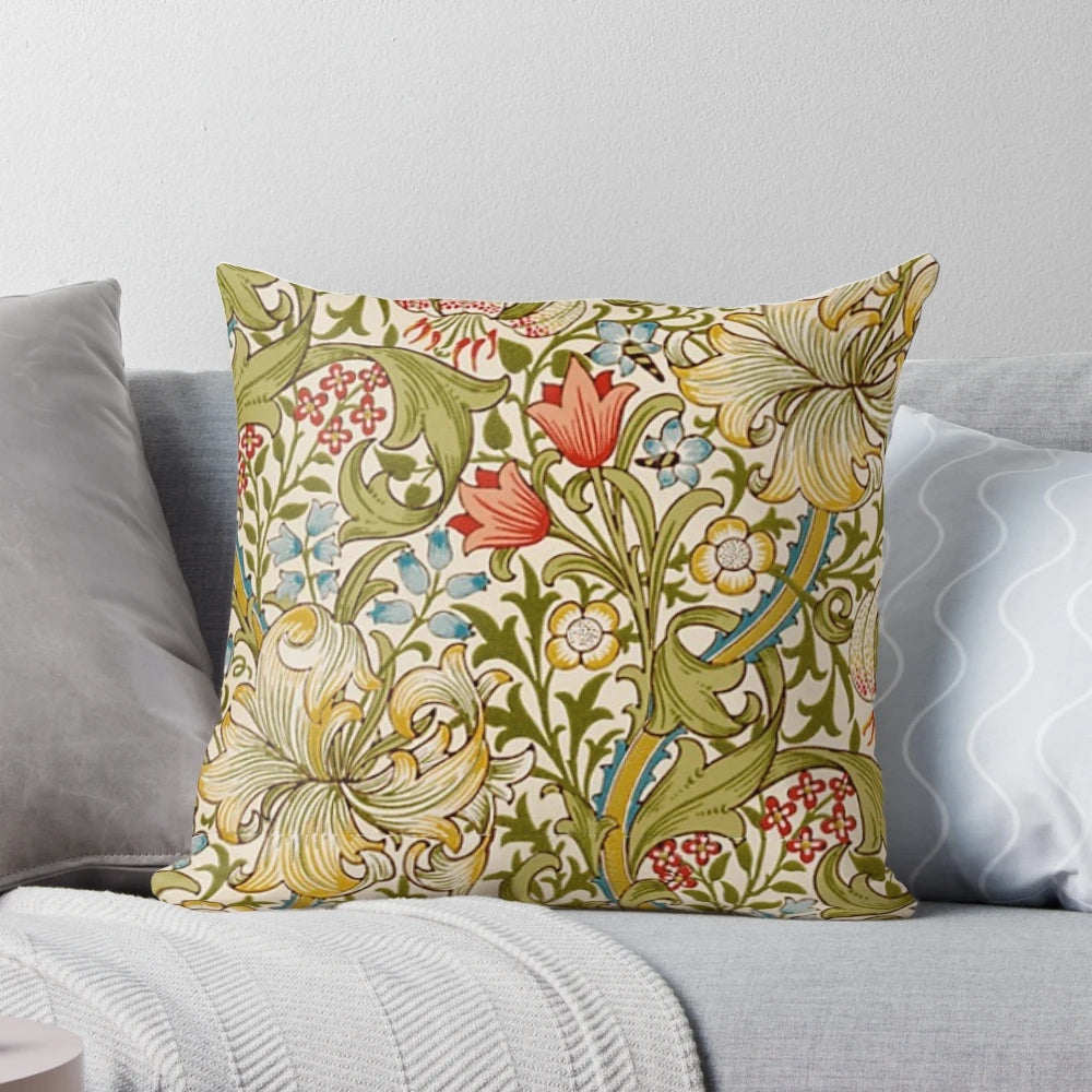 A decorative pillow featuring a golden lily flower pattern, inspired by the designs of the English Arts and Crafts movement.