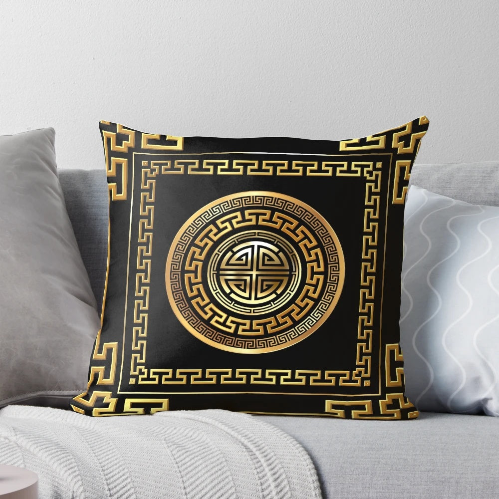 Black and gold decorative pillow with a Greek key meander pattern design