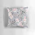 A decorative throw pillow with a beautiful grey chinoiserie bird pattern design.