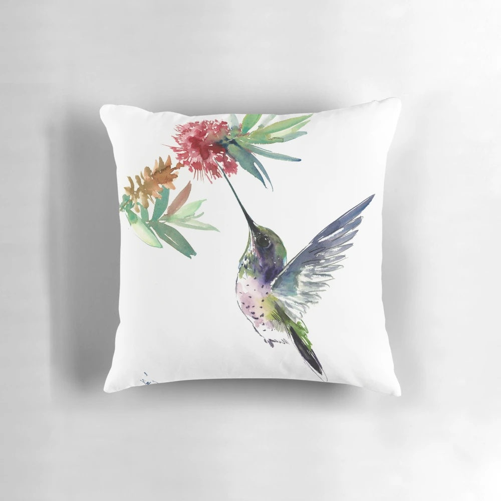 Vibrant hummingbird and flower design on a soft, decorative pillow